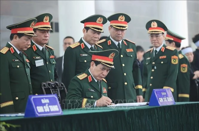 Đại tướng Phan Văn Giang, Phó Bí thư Quân ủy Trung ương, Bộ trưởng Bộ Quốc phòng ghi sổ tang tại lễ viếng nguyên Chủ tịch nước Trần Đức Lương.